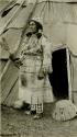 Thompson River Indian woman "KwElEmakst" in costume, in front of tepee