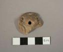 Pottery spindle whorl in form of animal head with open mouth