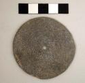 Disc--possible spindle whorl. discoidal, flat. one perforation in center. ground