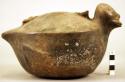 Pottery jar mouth in center of cross handle, bird shaped
