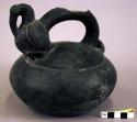 Black stirrup spouted pottery jar