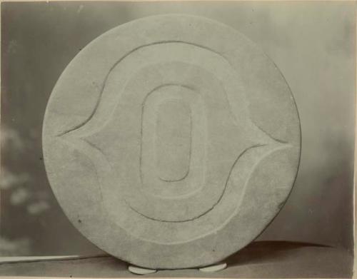 Round stone disc with geometrical decorations