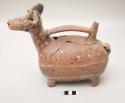 Effigy vessel, llama with ear tassels, broken spout, bridge handle, polychrome painted bands of decoration; extensively repaired badly