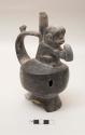 Effigy vessel, single stirrup pot with monkey holding something and bird on handle; anular base broken; loss to spout