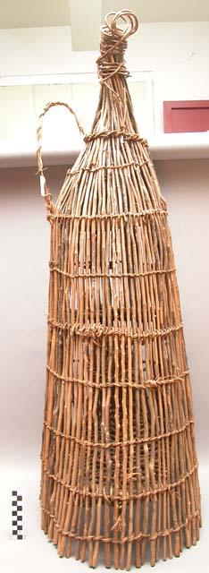 Fish trap- long stick held together by fibre twine weave, conical