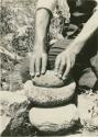 Small metate and brazo of red sandstone