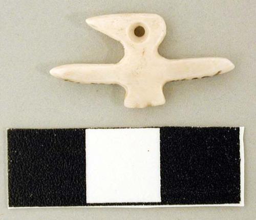 Carved shell pendant in the form of a bird