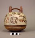 Double spout bottle painted with mask and eye motifs
