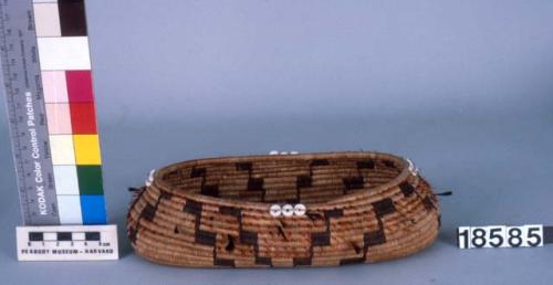 Oval feathered basket--dimensions of rim 3.5 x 6.5 in.