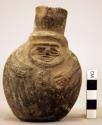 Black ware vase, human effigy