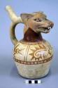 Ceramic bottle, stirrup spout, animal effigy, molded head, red on cream painted