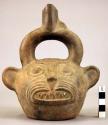 Pottery jar mouth in center of cross handle, animal shape