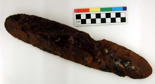 Chipped implement, red and black mottled obsidian