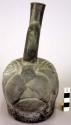 Ceramic bottle, stirrup spout, animal effigy, molded head, ears, incised face
