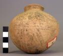 Pottery vessel- typical handled ware with white slip all over it- black paint de