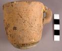 Plain round-bottomed pottery cup with on small vertical handle (formerly had rin