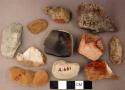 Chipped stone, flakes and prismatic blades, some with retouching or use wear, one possible burin; chipped stone, scraper; bone fragment, burned, possible rib