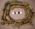 String of nephrite and shell beads with 5 pendant nephrite beads in shape of hea