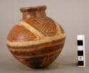 Pottery jar, red, with white band and black ornamentation