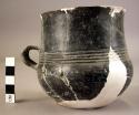 Ceramic cup, incised, 1 handle, black burnished, mended and reconstructed