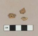 Carved bone fragments with pierced holes; possible button fragments