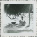 Photograph album, Yaruro fieldwork, p. 6, photo 2, thatched building with woman next to pot