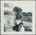 Photograph album, Yaruro fieldwork, p. 11, photo 1, man with bucket