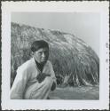 Photograph album, Yaruro fieldwork, p. 50, photo 2, man in front of thatched building