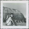 Photograph album, Yaruro fieldwork, p. 52, photo 1, young girl outside thatched building
