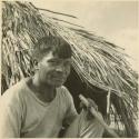 Photograph album, Yaruro fieldwork, p. 54, photo 1, man outside thatched building