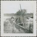 Photograph album, Yaruro fieldwork, p. 55, photo 2, men in a canoe on the water