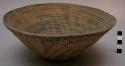 Bundle coiled bowl. Small base w/ sides flaring outwards. Complex fret design