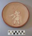 Incised ceramic plate:  deer dancer motif