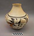 Polychrome-on-white vase: geometric and parrot motifs