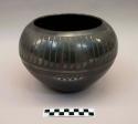 Black-on-black ceramic bowl: feather motif