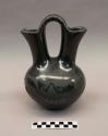 Black-on-black wedding vase: avanyu motif