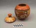 Polychrome-on-buff jar with lid: parrot motif