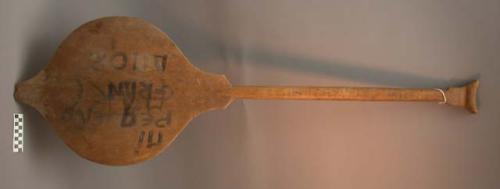 Paddle with wide blade, fruit shaped, painted lettering on blade