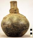 Pottery jar, handle on side, black, human form