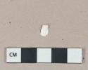 White shell fragment, highly degraded