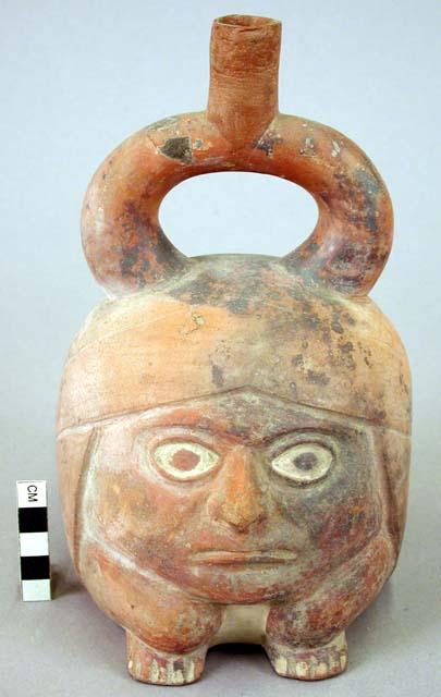 Ceramic bottle, stirrup spout, human effigy, molded face, feet & legs
