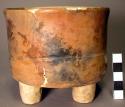 Restored tan flat-bottomed straight-sided pottery tripod bowl