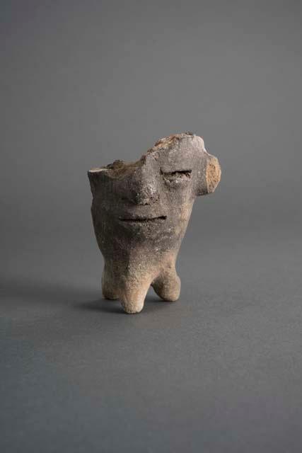 Ceramic partial effigy vase, molded human face, 3 conical legs, broken.