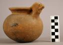 Unpainted pottery jar with spout in form of bird's head