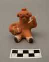 Ceramic figure of mudhead drummer, holding wooden drumstick; signed "A. Shije"