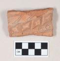 Coarse red bodied earthenware body sherd, with red slip and molded and incised decoration