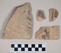 Coarse red bodied earthenware body sherds, with buff slip and black slipped decoration