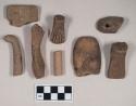 Red bodied earthenware figurine sherds, some with red pigment, some with pierced holes