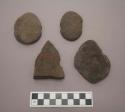 Ground stone, sinkers?, flat with notches at sides, two sinkers are oval shaped, one is broken