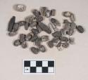 Shell beads and bead fragments, some ovoid, some tubular, some discoidal; burned and calcined